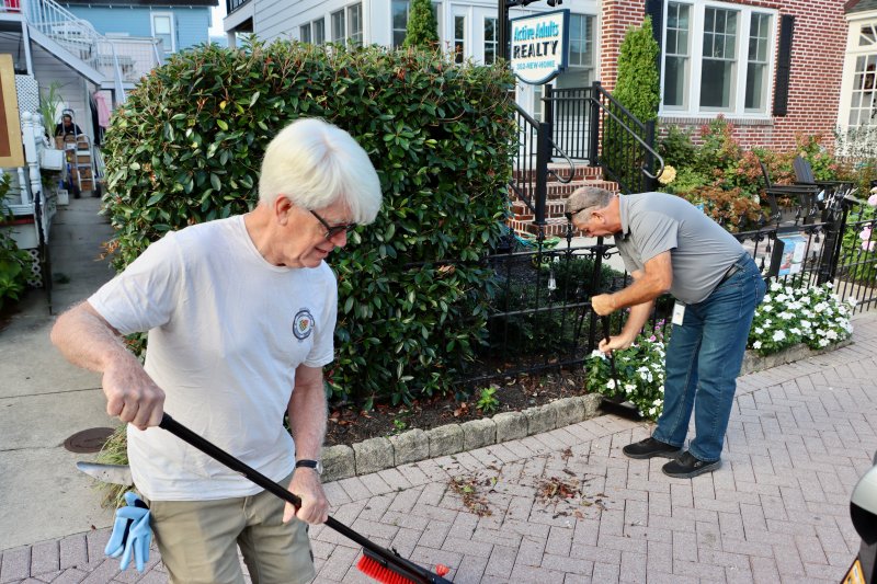 Councilman Tim Ritzert, left, and Lewes of Board of Public Works General Manager Robin Davis clean up Second Street.